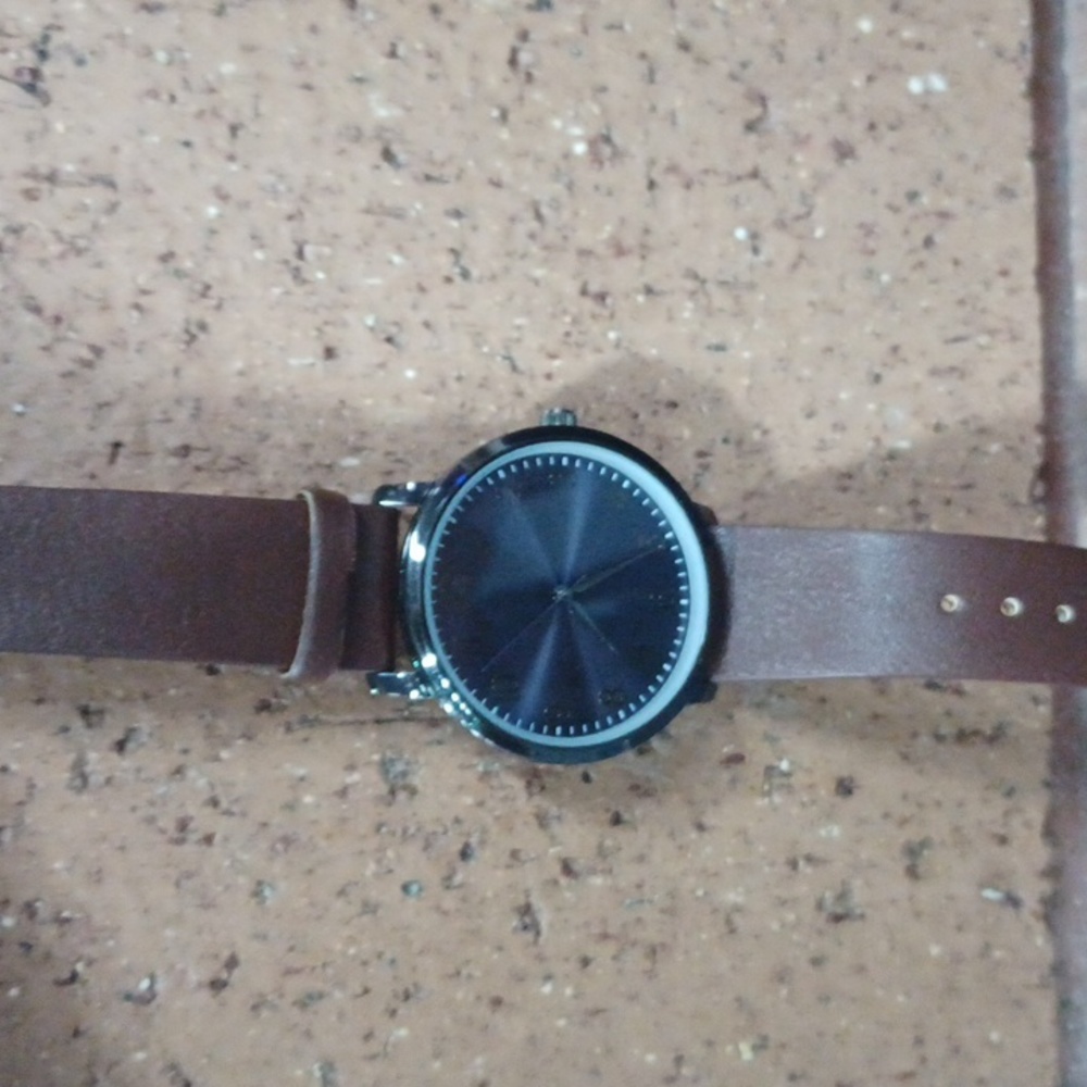 Men's watch brown leather strap. Dark silver and a glossy blue background.